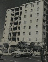 Black & white - block of flats with street, cars & robot in front by Van Bosch, Cobus
